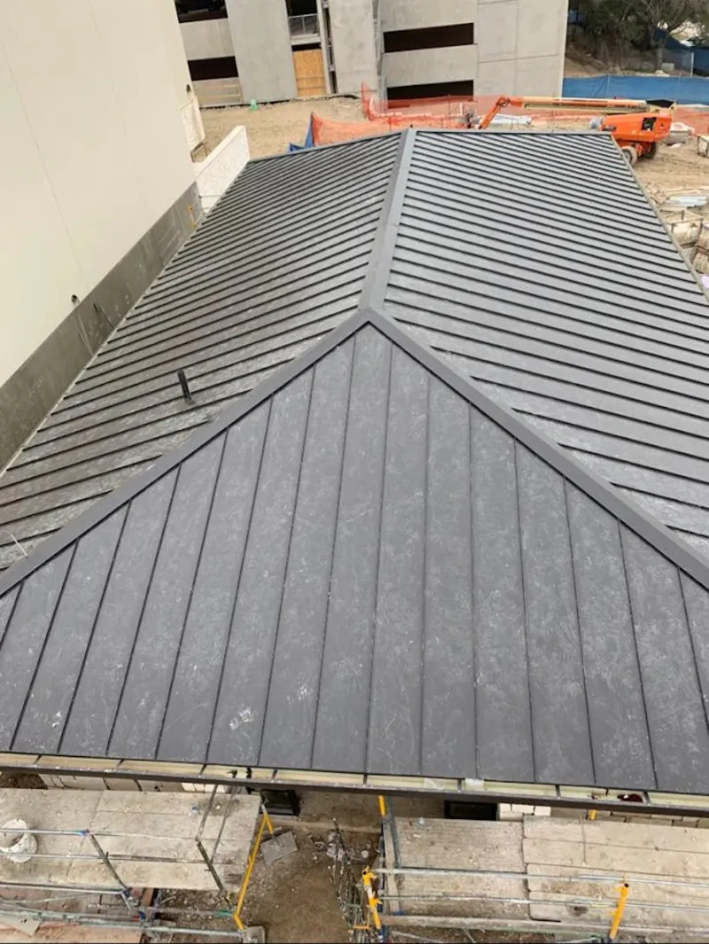 Commercial metal roof construction with crane equipment in Lyndon